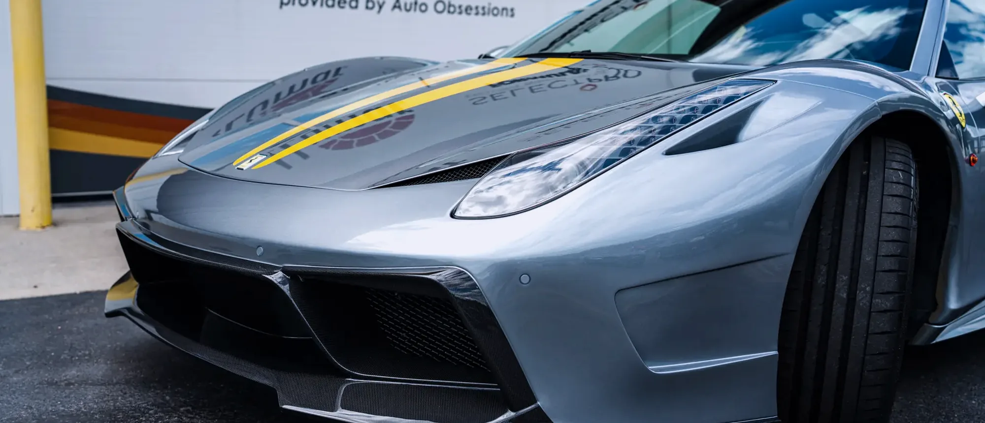 Ferrari finished in paint protection film outside the Auto Obsessions bay